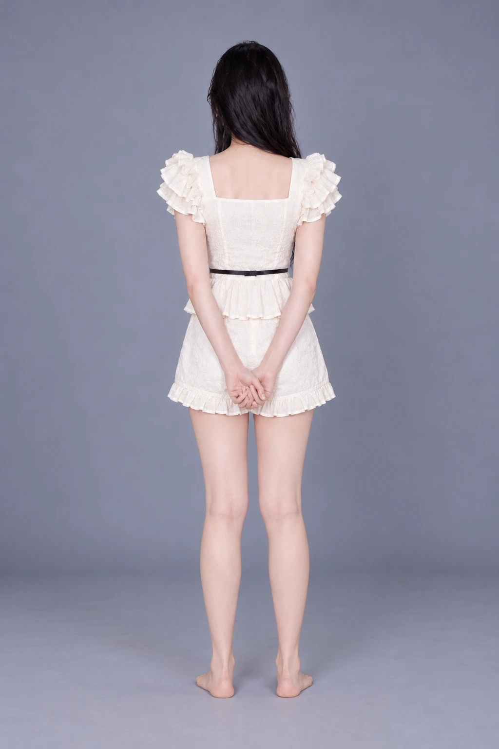 Standing with hands clasped in front / Reference view