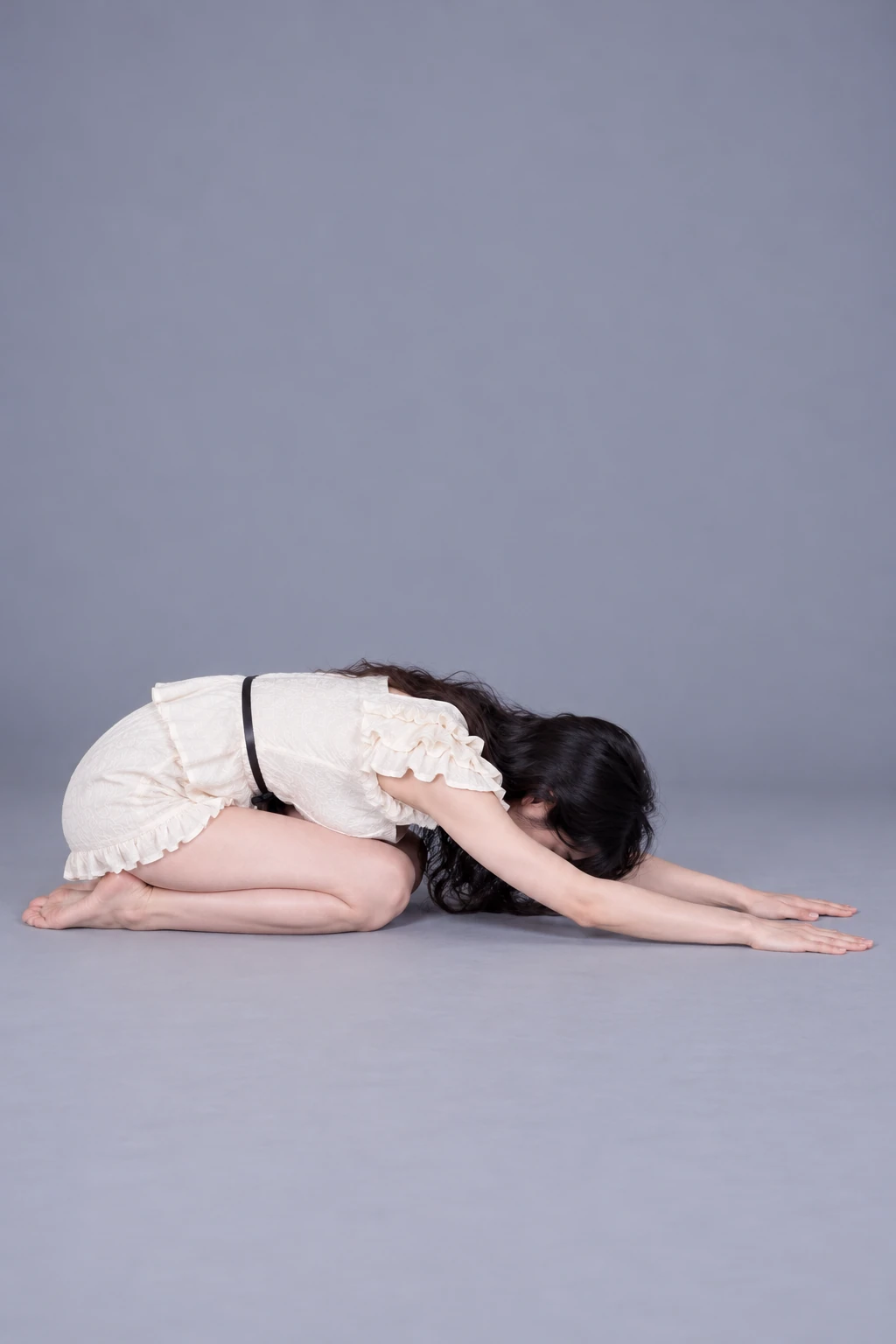 Kneeling forward fold with arms extended / Reference view